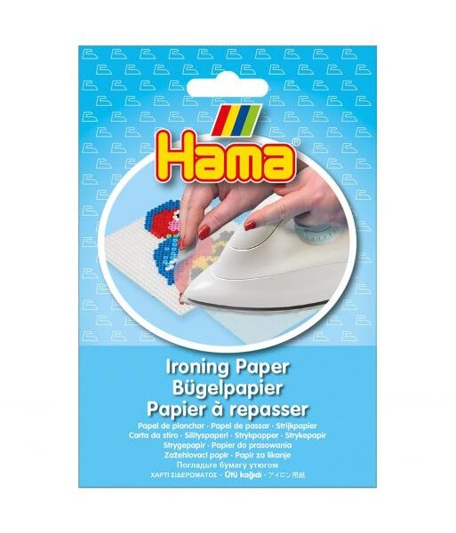 Hama strijkpapier verpakking met strijkijzer en kleurrijke strijkkralen op wit papier
